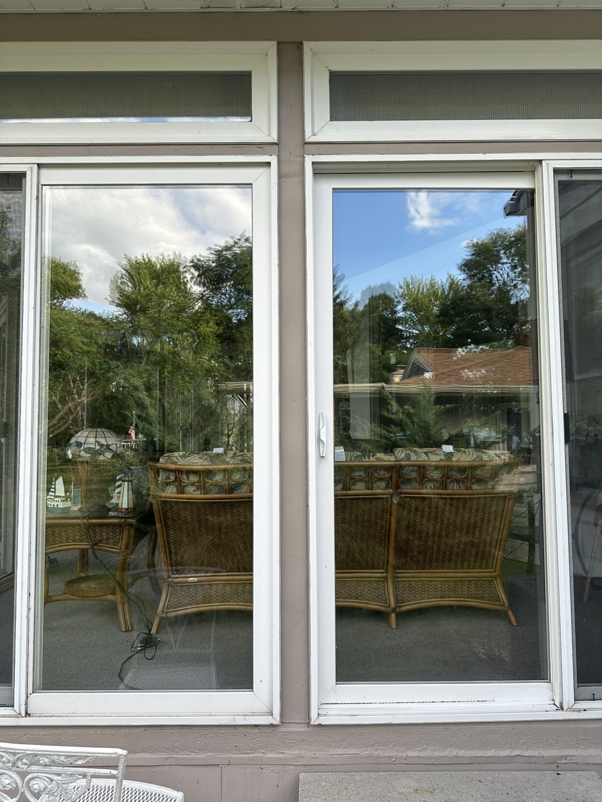 Crystal-clear patio doors reflecting a bright blue Wisconsin sky
