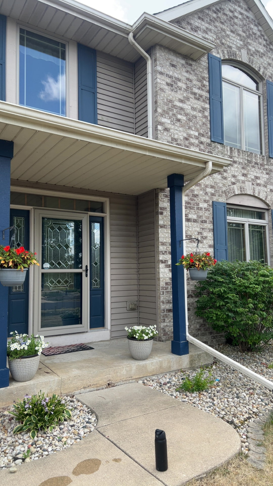 Beautiful two-story home with crystal clear windows and navy shutters